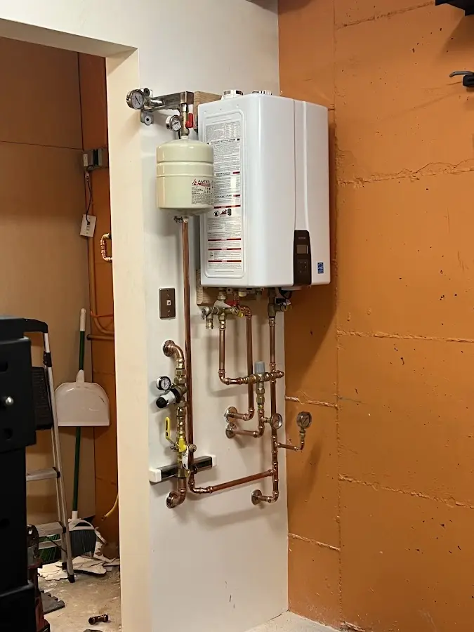 Plumbing technician inspecting water heater connections in Ladera Ranch